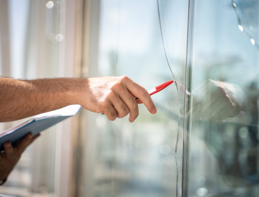 glass broken from a house by an accident, man checking to repair